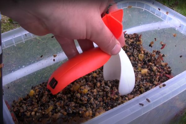 Loading up a spomb with spod mix A spomb being loaded with attractive spod mix